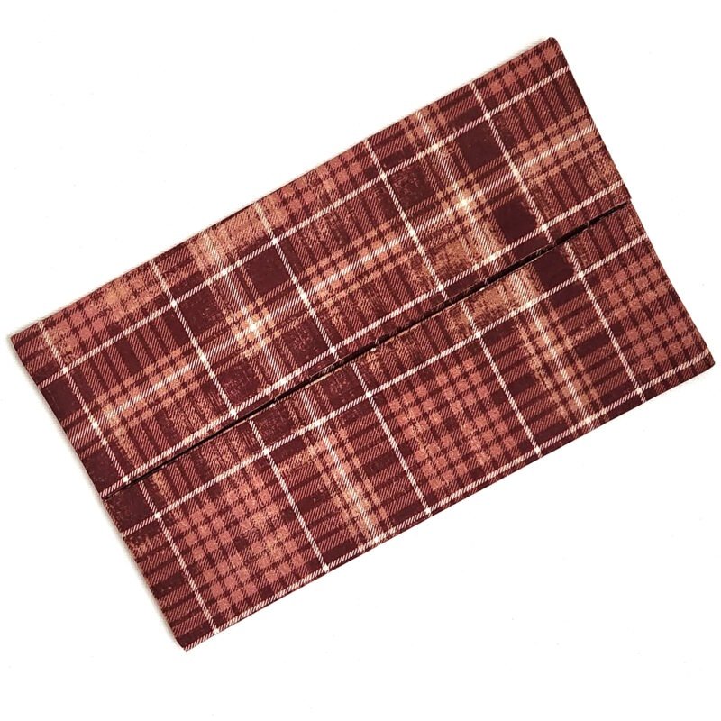 Plaid pattern in shades of reddish brown, brick orange and white